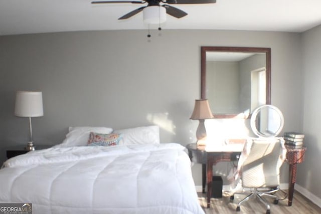 bedroom with ceiling fan and hardwood / wood-style flooring