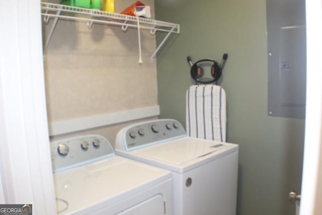 clothes washing area featuring separate washer and dryer and electric panel