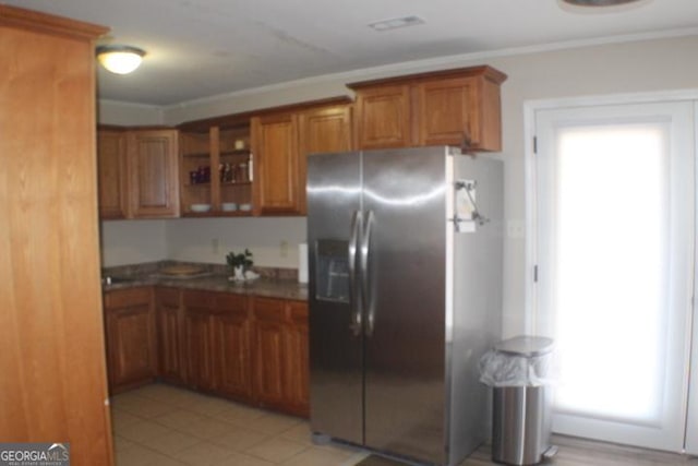 kitchen with stainless steel refrigerator with ice dispenser and crown molding