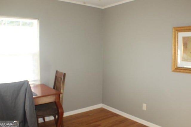 dining area featuring a healthy amount of sunlight, crown molding, and hardwood / wood-style flooring