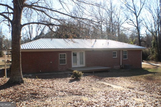 back of property featuring cooling unit and french doors