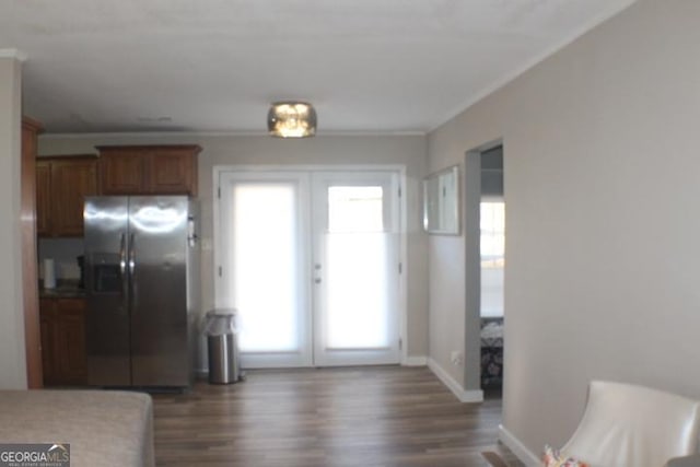 kitchen featuring stainless steel fridge with ice dispenser, dark wood-type flooring, ornamental molding, and french doors