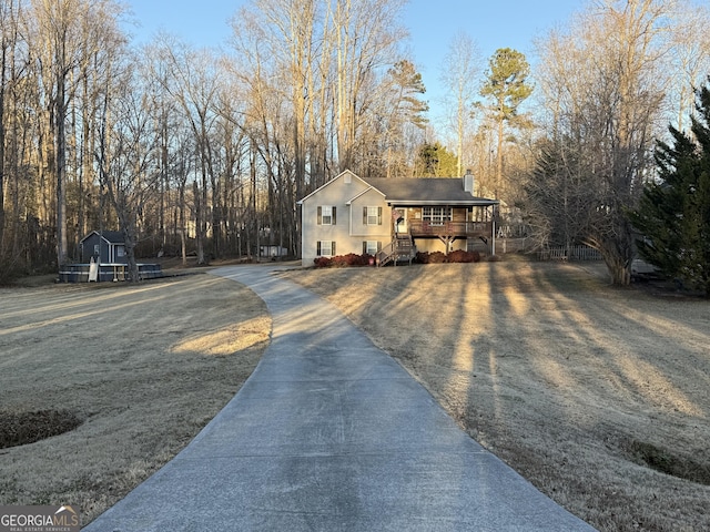 view of front of home featuring covered porch and a front lawn