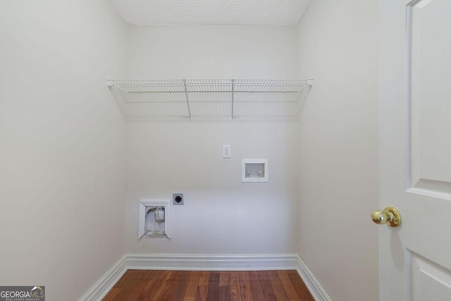 washroom with a textured ceiling, hookup for an electric dryer, hardwood / wood-style flooring, and washer hookup