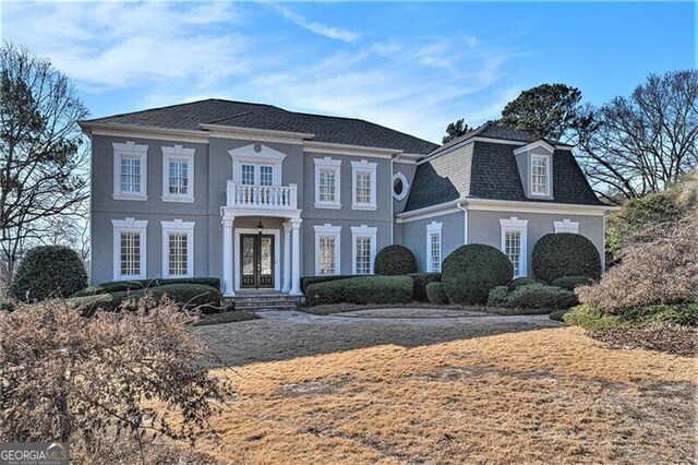 view of front facade with french doors and a balcony