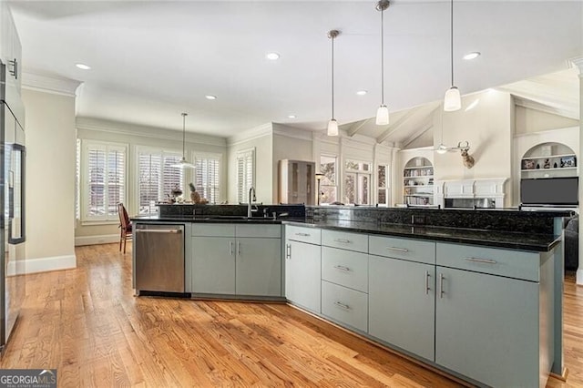 kitchen with hanging light fixtures, dishwasher, a center island with sink, and built in features