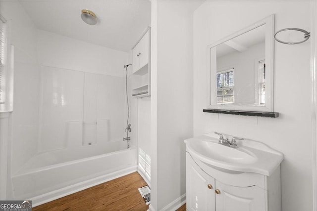 bathroom featuring shower / bath combination, vanity, and hardwood / wood-style floors