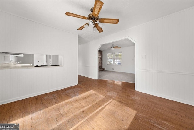 unfurnished living room featuring ceiling fan and wood-type flooring