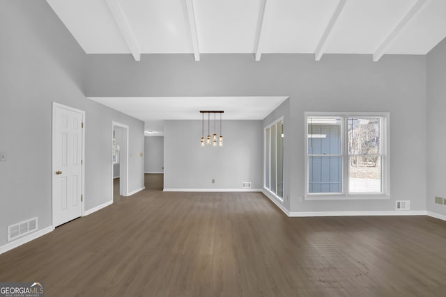 unfurnished living room featuring dark hardwood / wood-style floors, beamed ceiling, and a chandelier