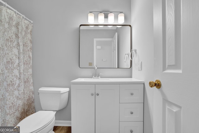 bathroom featuring toilet and vanity