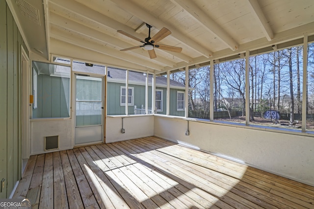 unfurnished sunroom featuring ceiling fan, vaulted ceiling with beams, and wood ceiling