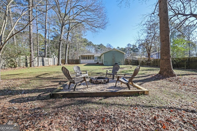 view of yard featuring a storage unit and a fire pit