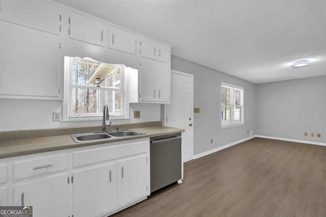 kitchen with white cabinetry, dishwasher, hardwood / wood-style floors, and sink