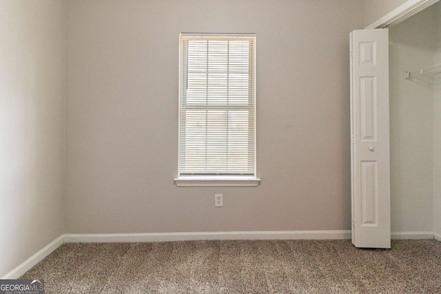 unfurnished bedroom featuring a closet and carpet flooring