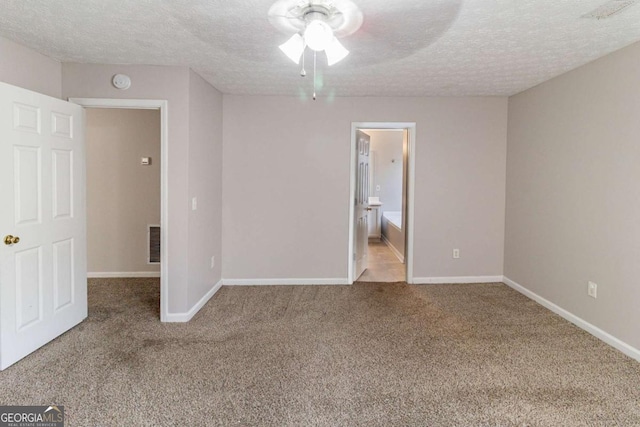 unfurnished bedroom featuring ceiling fan, light carpet, and a textured ceiling