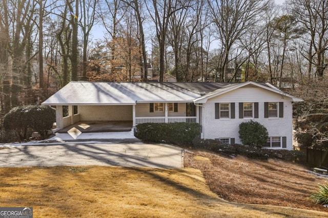 view of front of property featuring a carport and a porch