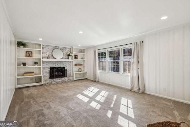 unfurnished living room with crown molding, light carpet, and a fireplace