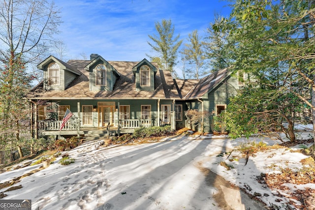 new england style home featuring covered porch