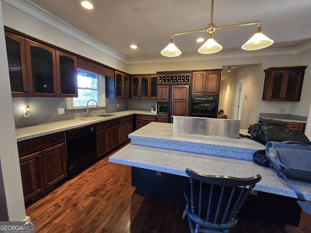 kitchen with decorative light fixtures, backsplash, black appliances, sink, and ornamental molding