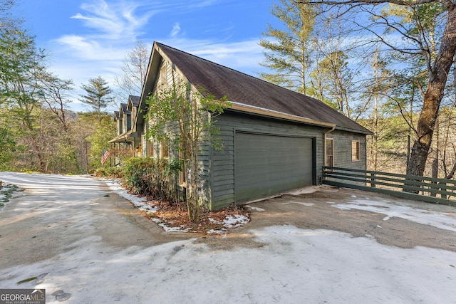 view of side of property featuring an outbuilding and a garage