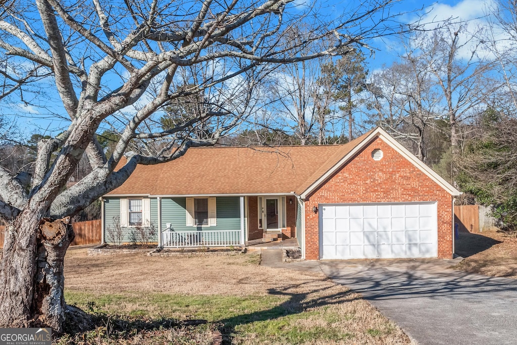 ranch-style house with a garage and a porch