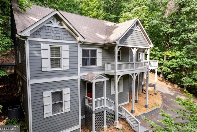 view of front facade with central air condition unit and a balcony