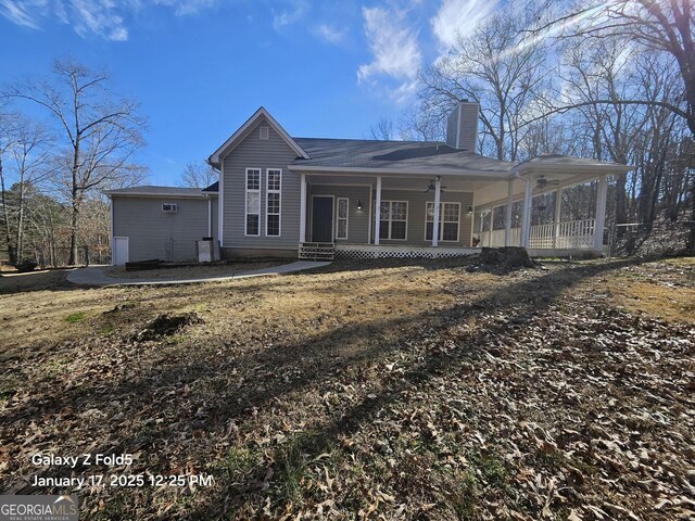 back of property with a porch