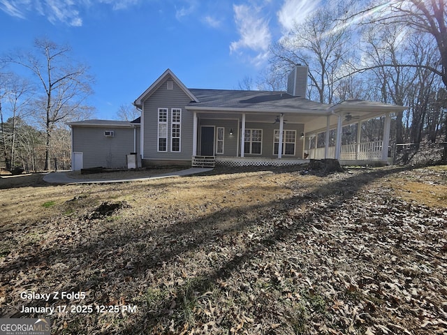 rear view of property featuring covered porch