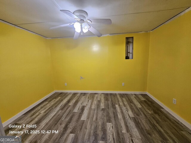 empty room with ceiling fan, wood finished floors, and baseboards