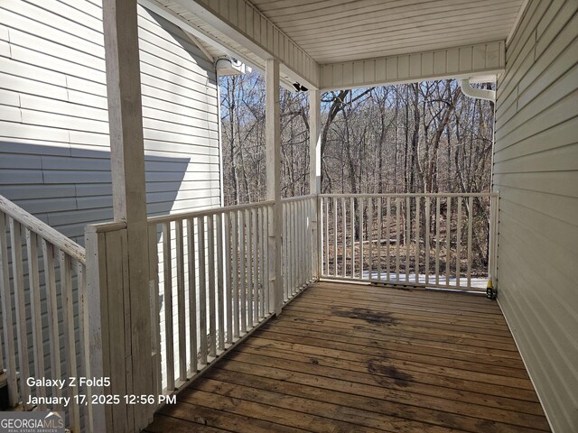 spare room with ceiling fan, wood finished floors, and baseboards