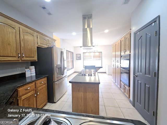 kitchen featuring black appliances, light tile patterned flooring, island range hood, and a kitchen island