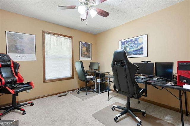 office area featuring a textured ceiling, ceiling fan, and carpet floors