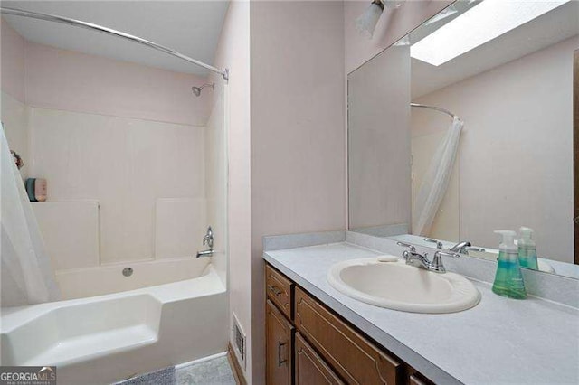 bathroom featuring shower / tub combo and vanity