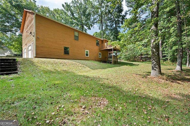 view of home's exterior with a deck and a lawn