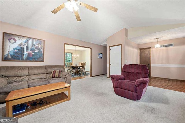 living room featuring ceiling fan, carpet floors, and lofted ceiling