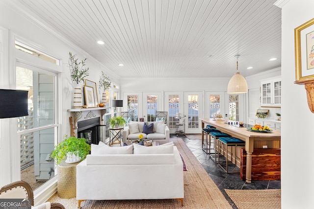 living room with crown molding, wood ceiling, and french doors