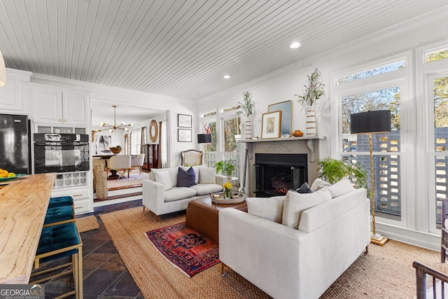 living room featuring wood ceiling, crown molding, and a chandelier