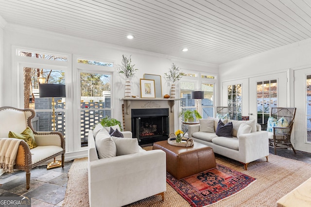 living room featuring french doors, crown molding, and wood ceiling