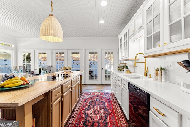 kitchen featuring black appliances, white cabinets, french doors, and sink