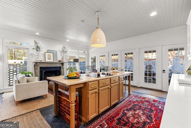 kitchen featuring decorative light fixtures, french doors, crown molding, and wood ceiling