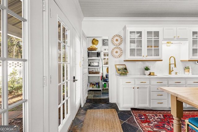 bar featuring white cabinetry, plenty of natural light, and sink