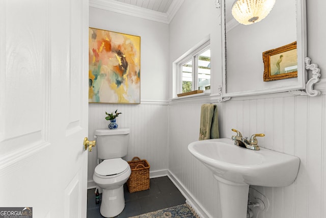 bathroom featuring toilet and ornamental molding