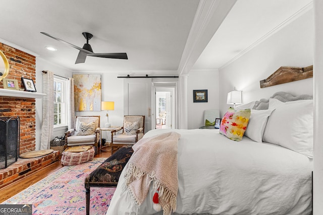 bedroom featuring ceiling fan, ornamental molding, hardwood / wood-style floors, and multiple windows