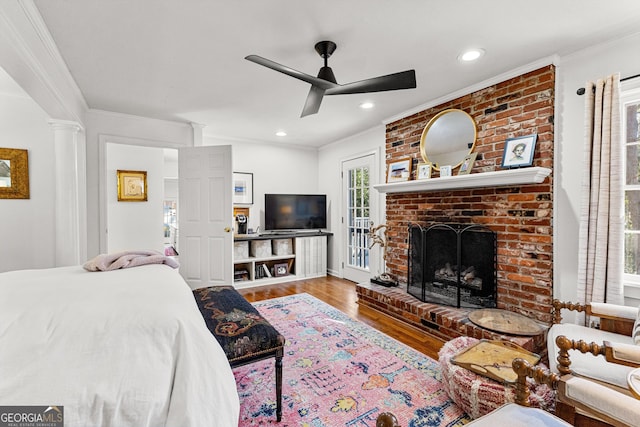 bedroom with ceiling fan, wood-type flooring, and crown molding