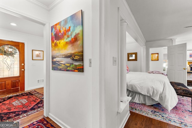 foyer featuring dark wood-type flooring and ornamental molding