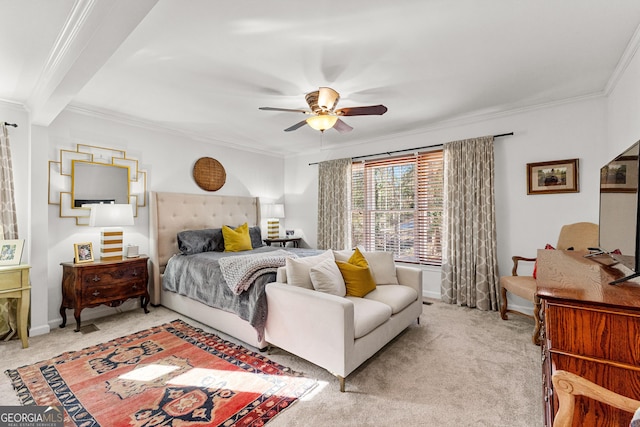 carpeted bedroom featuring ceiling fan and crown molding