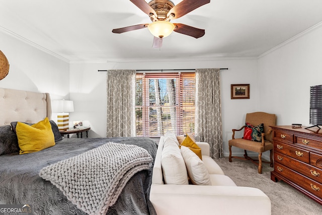 carpeted bedroom featuring ceiling fan and crown molding