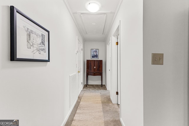 hall featuring light carpet and crown molding