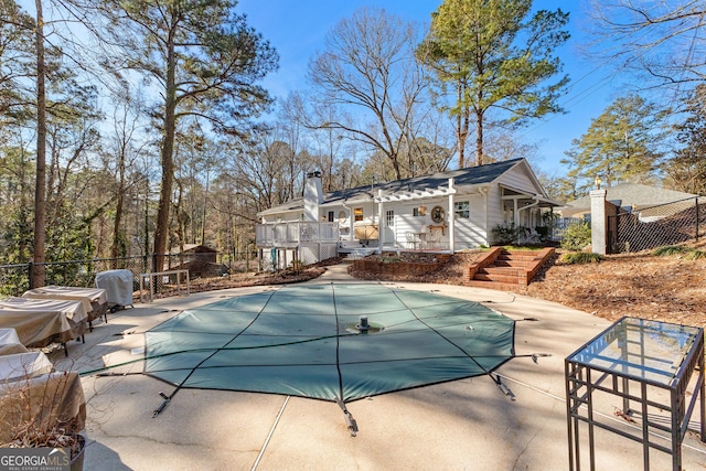 view of pool with a patio area and an outdoor structure