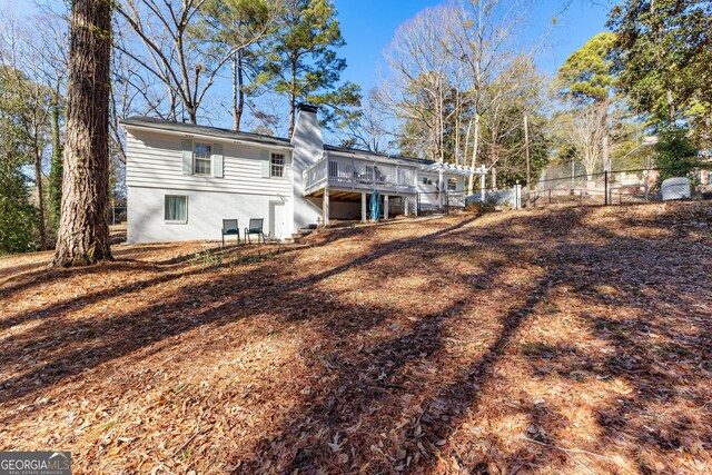 rear view of property featuring a pergola